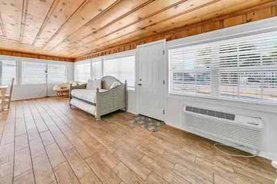 a living room with a couch and a fan at If Its The Beaches by Emerald Coast Retreats in Panama City Beach