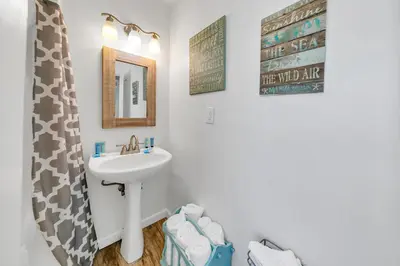 a bathroom with a sink and a mirror at If Its The Beaches by Emerald Coast Retreats in Panama City Beach