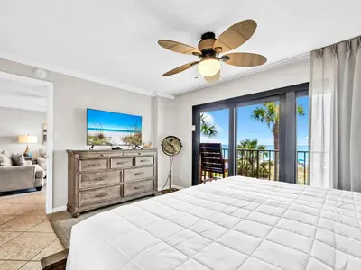 a bedroom with a bed and a ceiling fan at Commodore 203 in Panama City Beach
