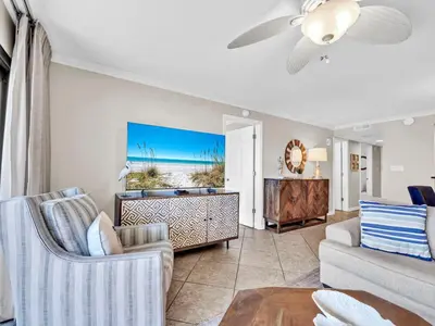 a living room with a couch and a table at Commodore 203 in Panama City Beach