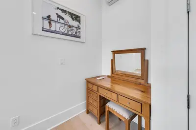 a dressing room with a mirror and a wooden dresser at Just Breezin' in Santa Rosa Beach
