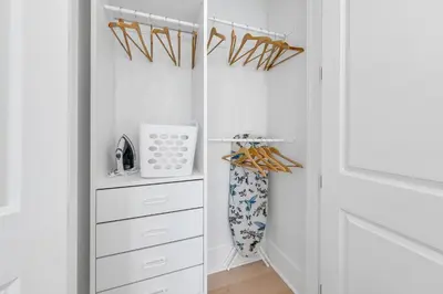 a white walk in closet with white cabinets at Just Breezin' in Santa Rosa Beach