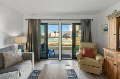 a living room with a couch and a chair at Sugar Beach C36 in Panama City Beach