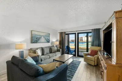 a living room with a couch and a tv at Sugar Beach C36 in Panama City Beach