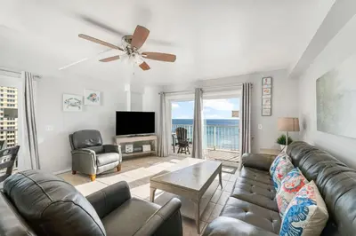 a living room with a couch and a ceiling fan at The Summit 1032 in Panama City Beach