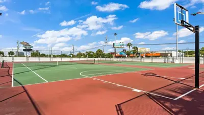 a tennis court with a net on top of it at The Summit 1032 in Panama City Beach