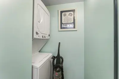 a bathroom with a washer and dryer next to a washing machine at The Summit 1032 in Panama City Beach