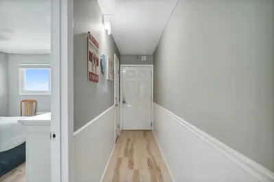 a hallway with white walls and a white door at The Summit 1222 in Panama City Beach