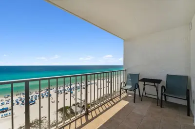 a balcony with a table and chairs and the beach at The Summit 1222 in Panama City Beach