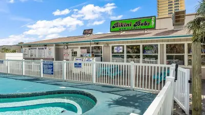 a restaurant with a pool in front of a building at The Summit 1222 in Panama City Beach