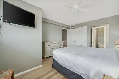 a bedroom with a bed and a flat screen tv at The Summit 1222 in Panama City Beach