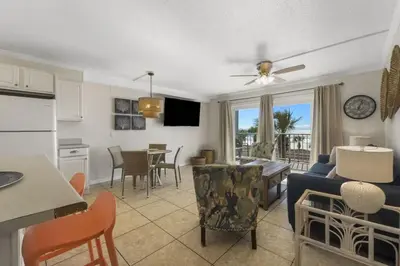 a kitchen and a living room with a couch and a table at The Summit 321 in Panama City Beach