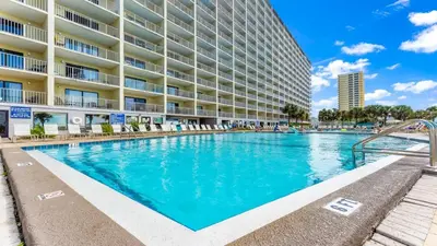 a swimming pool in front of a large apartment building at The Summit 321 in Panama City Beach