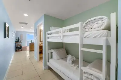 two bunk beds in a room with a hallway at Splash 804E in Panama City Beach