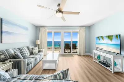 a living room with a couch and a tv at Stunning 4BD! Oceanview! Free Beach Chair Service! Sleeps 10! By Dolce Vita Getaways in Panama City Beach