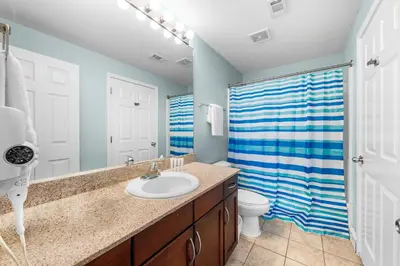 a bathroom with a sink and a toilet and a shower at Stunning 4BD! Oceanview! Free Beach Chair Service! Sleeps 10! By Dolce Vita Getaways in Panama City Beach