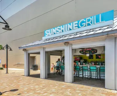 a sun shine grill sign on the side of a building at Stunning 4BD! Oceanview! Free Beach Chair Service! Sleeps 10! By Dolce Vita Getaways in Panama City Beach