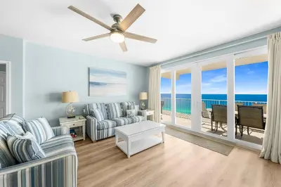 a living room with a couch and a ceiling fan at Stunning 4BD! Oceanview! Free Beach Chair Service! Sleeps 10! By Dolce Vita Getaways in Panama City Beach