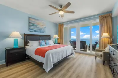 a bedroom with a bed with a view of the ocean at Stunning 4BD! Oceanview! Free Beach Chair Service! Sleeps 10! By Dolce Vita Getaways in Panama City Beach