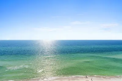 an aerial view of the ocean with people on the beach at Treasure Island #1203 by Book That Condo in Panama City Beach