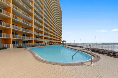 a swimming pool in front of a large apartment building at Treasure Island #1203 by Book That Condo in Panama City Beach