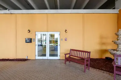 a wooden bench sitting in front of a door at Treasure Island #1203 by Book That Condo in Panama City Beach