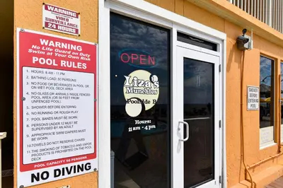 a sign on the door of a restaurant with a no driving sign at Treasure Island #1203 by Book That Condo in Panama City Beach