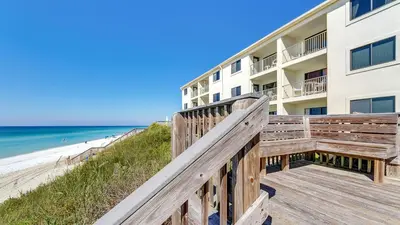 a boardwalk leading to the beach at a resort at Beachside Condo 24 Here comes the Sun in Santa Rosa Beach