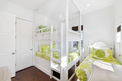 a bedroom with two bunk beds and a desk at Greenway Loop by 30A Escapes in Rosemary Beach