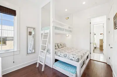 a bedroom with a bunk bed and a window at Greenway Loop by 30A Escapes in Rosemary Beach