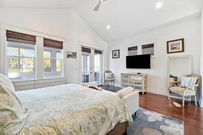 a bedroom with a bed and a flat screen tv at Greenway Loop by 30A Escapes in Rosemary Beach