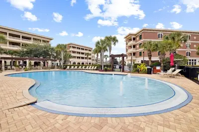 a large swimming pool in a courtyard with buildings at Villages of South Walton B324 by 30A Escapes in Rosemary Beach