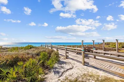a boardwalk to the beach with the ocean in the background at Villages of South Walton B324 by 30A Escapes in Rosemary Beach