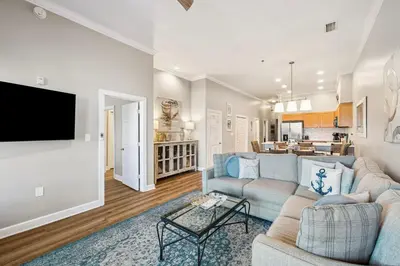 a living room with a couch and a tv at Villages of South Walton B324 by 30A Escapes in Rosemary Beach