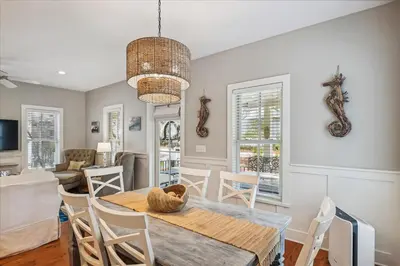 a dining room with a table and chairs at Sans Souci by 30A Escapes in Seacrest