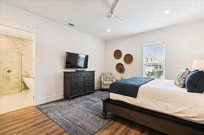 a bedroom with a bed and a flat screen tv at Family Tradition by 30A Escapes in Seacrest