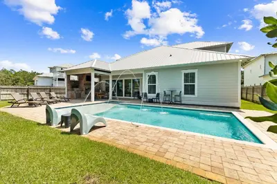 a house with a swimming pool in the yard at Family Tradition by 30A Escapes in Seacrest