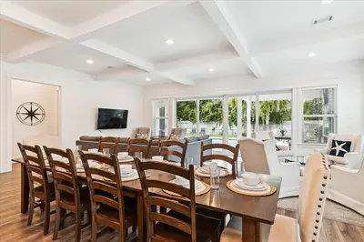 a dining room with a table and chairs at Family Tradition by 30A Escapes in Seacrest
