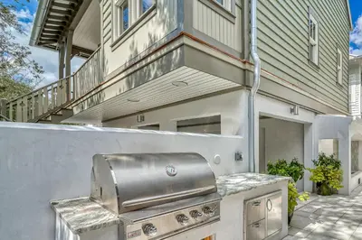 a barbecue grill on the side of a house at Sandy Haven by 30A Escapes in Rosemary Beach