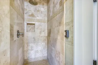 a bathroom with a shower with a glass door at Pappas Cottage by 30A Escapes in Rosemary Beach