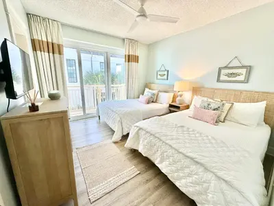 a bedroom with two beds and a television in it at HP 36W Condo by 30A Escapes in Rosemary Beach