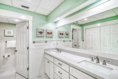 a bathroom with two sinks and a large mirror at HP 36W Condo by 30A Escapes in Rosemary Beach