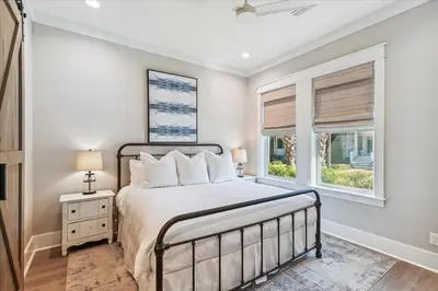 a bedroom with a bed and a window at At Ease by 30A Escapes in Rosemary Beach