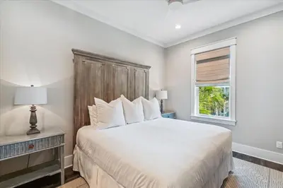 a bedroom with a large bed and a window at At Ease by 30A Escapes in Rosemary Beach