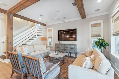a living room with two couches and a staircase at At Ease by 30A Escapes in Rosemary Beach
