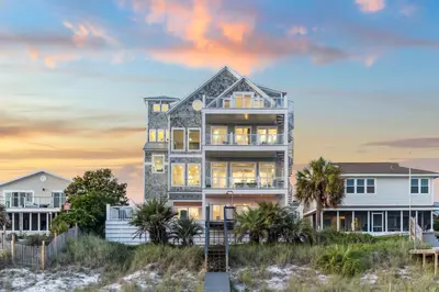 aominium building on the beach at sunset at Sea Castle by 30A Escapes in Sunnyside