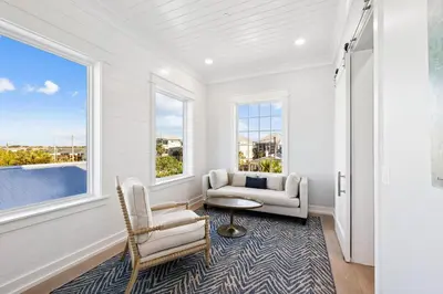 a living room with a couch and chairs and a table at Sea Castle by 30A Escapes in Sunnyside