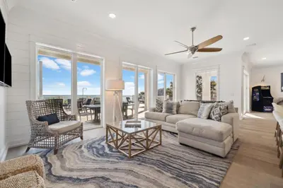 a living room with a couch and a table at Sea Castle by 30A Escapes in Sunnyside