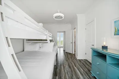 a bedroom with a bunk bed and a blue dresser at Walkin on Sunshine by 30A Escapes in Rosemary Beach