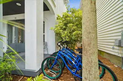 a group of blue bikes parked next to a house at Walkin on Sunshine by 30A Escapes in Rosemary Beach